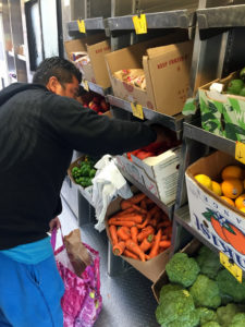 A client selects fresh produce from the Connecticut Food Bank GROW Truck.